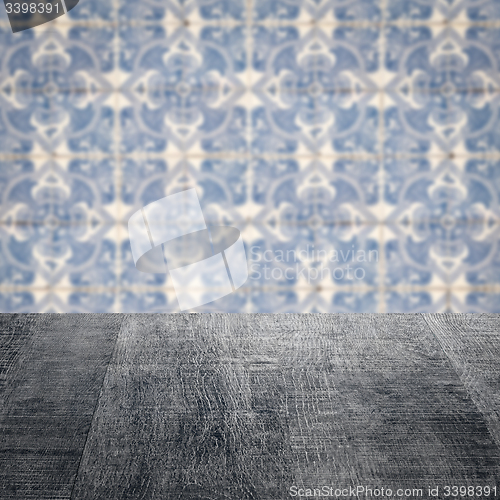 Image of Wood table top and blur vintage ceramic tile pattern wall