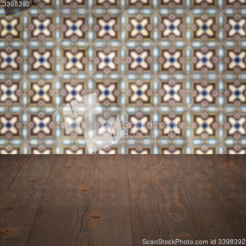 Image of Wood table top and blur vintage ceramic tile pattern wall