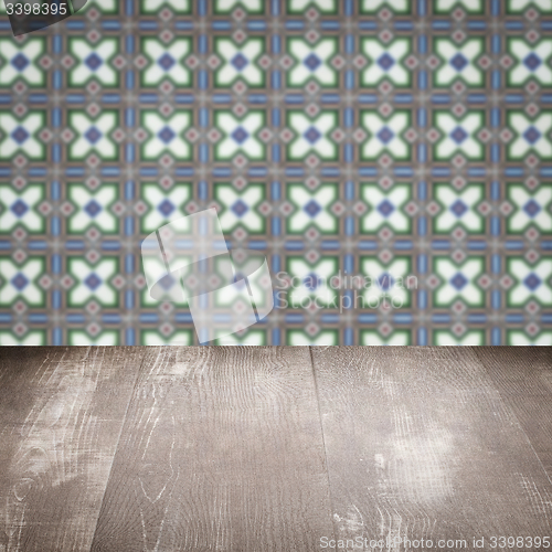 Image of Wood table top and blur vintage ceramic tile pattern wall