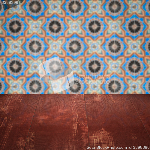 Image of Wood table top and blur vintage ceramic tile pattern wall