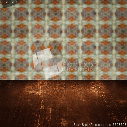 Image of Wood table top and blur vintage ceramic tile pattern wall