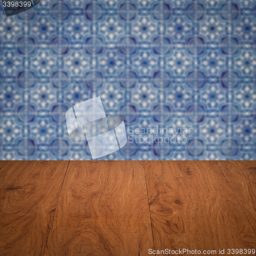 Image of Wood table top and blur vintage ceramic tile pattern wall