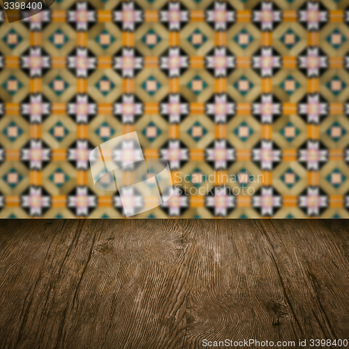 Image of Wood table top and blur vintage ceramic tile pattern wall