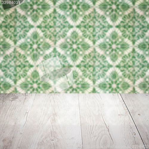 Image of Wood table top and blur vintage ceramic tile pattern wall