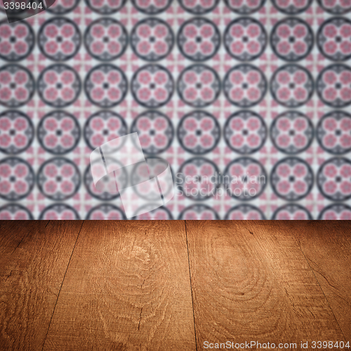 Image of Wood table top and blur vintage ceramic tile pattern wall