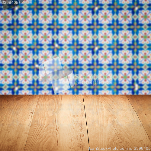 Image of Wood table top and blur vintage ceramic tile pattern wall