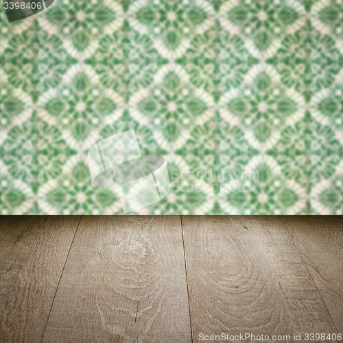 Image of Wood table top and blur vintage ceramic tile pattern wall