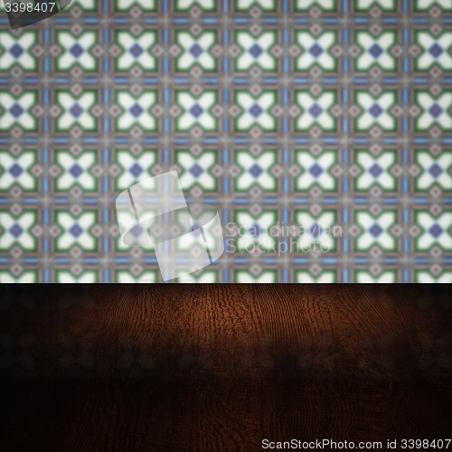 Image of Wood table top and blur vintage ceramic tile pattern wall