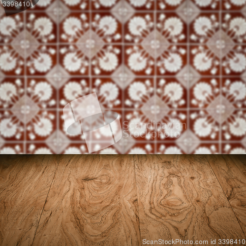 Image of Wood table top and blur vintage ceramic tile pattern wall