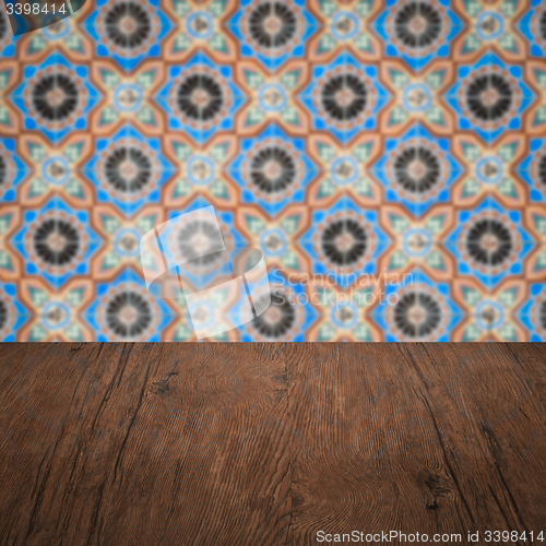 Image of Wood table top and blur vintage ceramic tile pattern wall