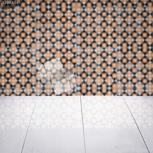 Image of Wood table top and blur vintage ceramic tile pattern wall