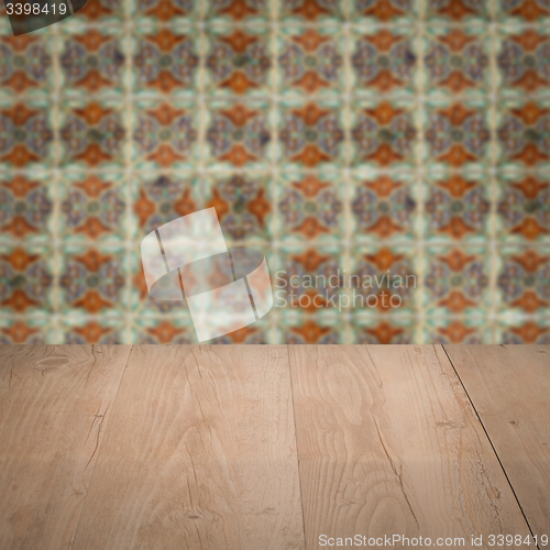 Image of Wood table top and blur vintage ceramic tile pattern wall