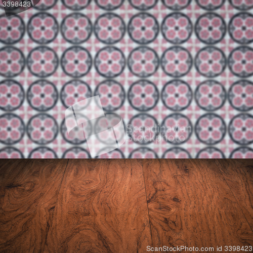 Image of Wood table top and blur vintage ceramic tile pattern wall