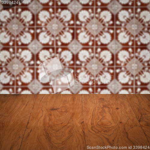 Image of Wood table top and blur vintage ceramic tile pattern wall