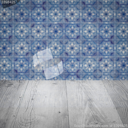 Image of Wood table top and blur vintage ceramic tile pattern wall