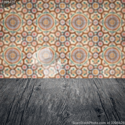 Image of Wood table top and blur vintage ceramic tile pattern wall