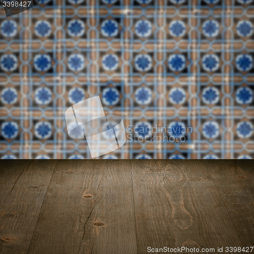 Image of Wood table top and blur vintage ceramic tile pattern wall