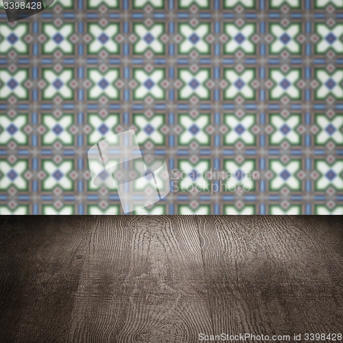 Image of Wood table top and blur vintage ceramic tile pattern wall