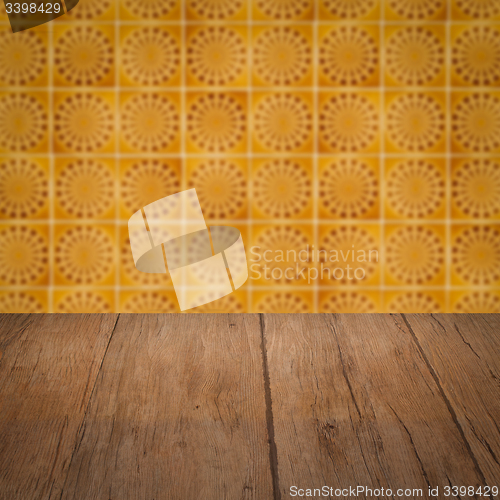 Image of Wood table top and blur vintage ceramic tile pattern wall