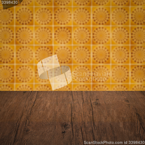 Image of Wood table top and blur vintage ceramic tile pattern wall