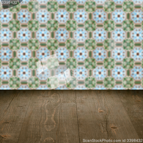 Image of Wood table top and blur vintage ceramic tile pattern wall