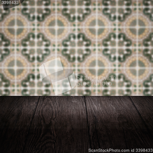 Image of Wood table top and blur vintage ceramic tile pattern wall