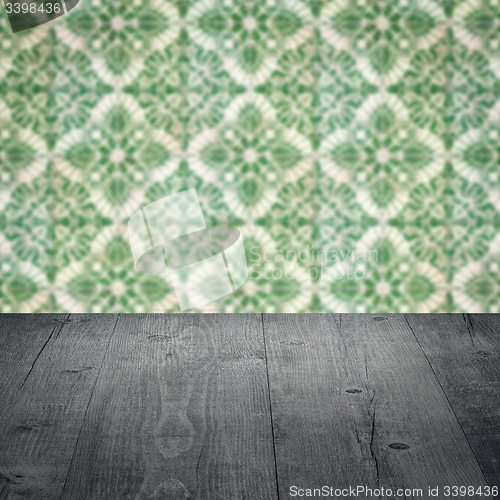 Image of Wood table top and blur vintage ceramic tile pattern wall