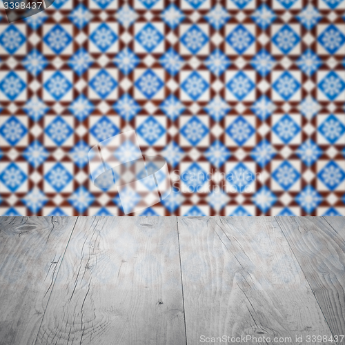 Image of Wood table top and blur vintage ceramic tile pattern wall