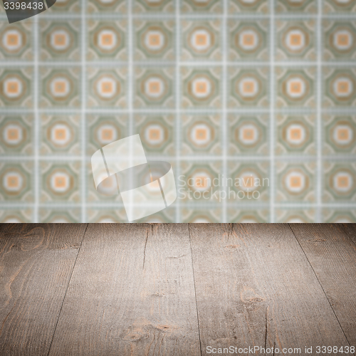 Image of Wood table top and blur vintage ceramic tile pattern wall