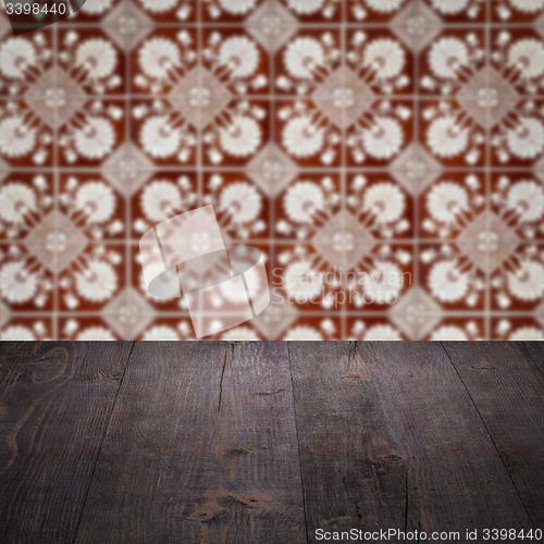 Image of Wood table top and blur vintage ceramic tile pattern wall