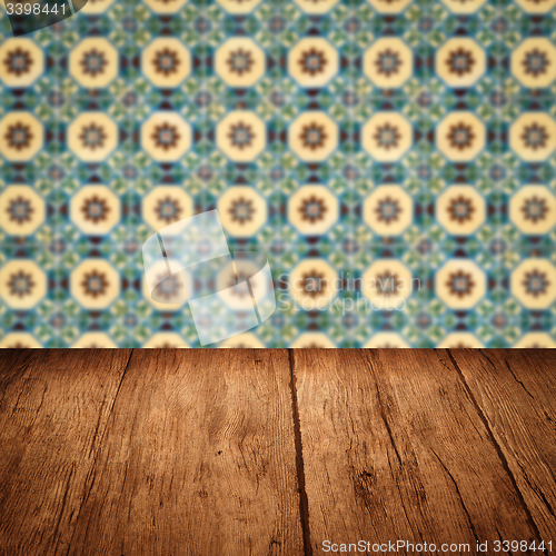 Image of Wood table top and blur vintage ceramic tile pattern wall