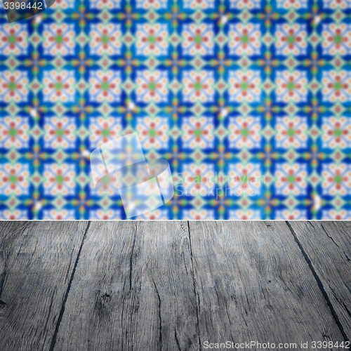 Image of Wood table top and blur vintage ceramic tile pattern wall