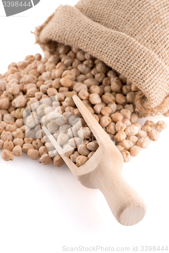 Image of Uncooked chickpeas and wooden scoop