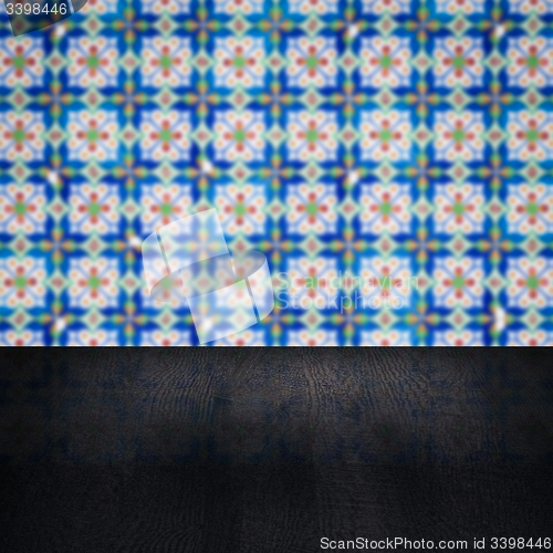 Image of Wood table top and blur vintage ceramic tile pattern wall