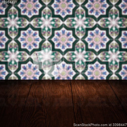 Image of Wood table top and blur vintage ceramic tile pattern wall