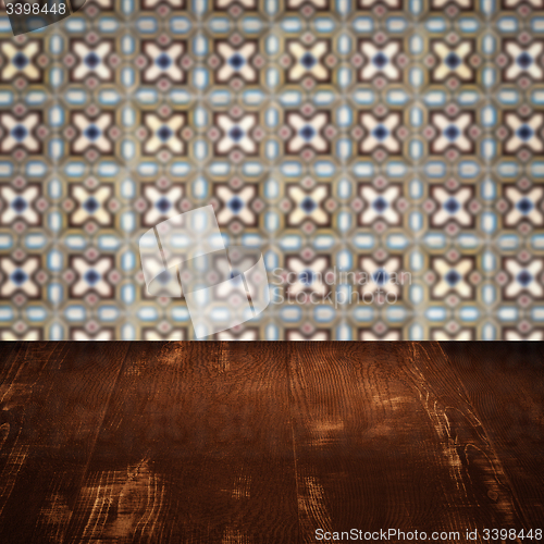 Image of Wood table top and blur vintage ceramic tile pattern wall