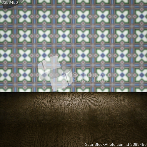 Image of Wood table top and blur vintage ceramic tile pattern wall