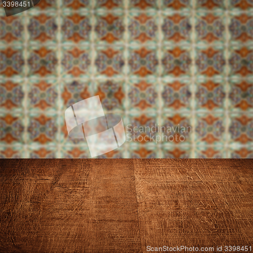 Image of Wood table top and blur vintage ceramic tile pattern wall