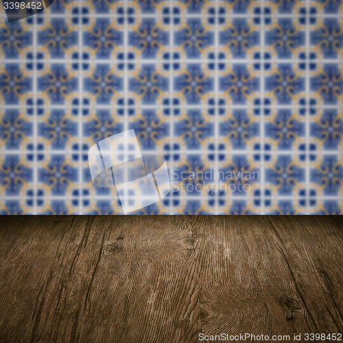 Image of Wood table top and blur vintage ceramic tile pattern wall