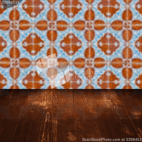 Image of Wood table top and blur vintage ceramic tile pattern wall