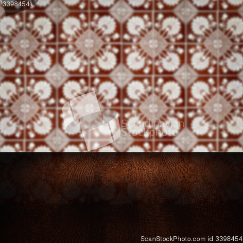 Image of Wood table top and blur vintage ceramic tile pattern wall