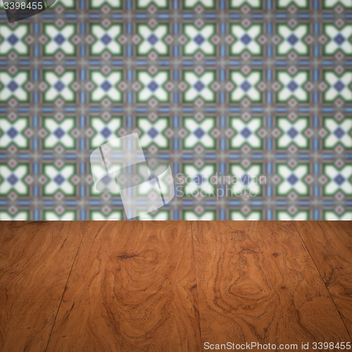 Image of Wood table top and blur vintage ceramic tile pattern wall