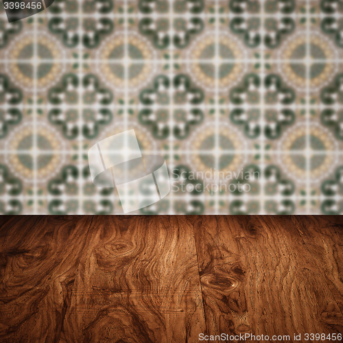 Image of Wood table top and blur vintage ceramic tile pattern wall