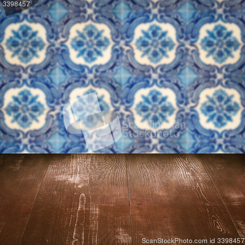 Image of Wood table top and blur vintage ceramic tile pattern wall