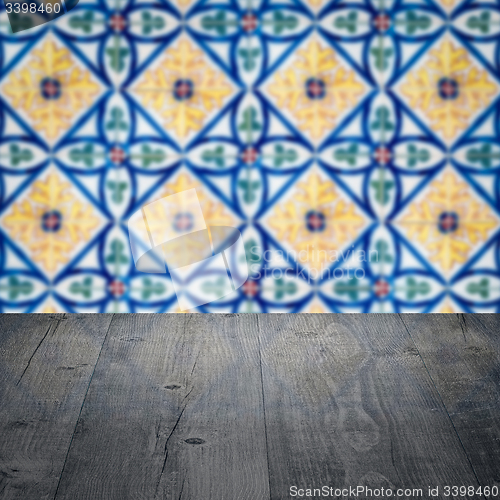 Image of Wood table top and blur vintage ceramic tile pattern wall