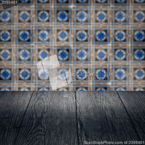 Image of Wood table top and blur vintage ceramic tile pattern wall