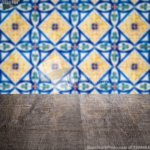 Image of Wood table top and blur vintage ceramic tile pattern wall