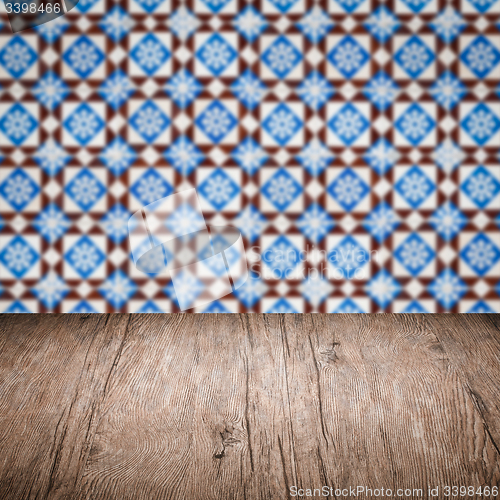 Image of Wood table top and blur vintage ceramic tile pattern wall