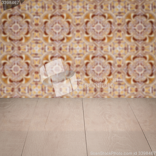 Image of Wood table top and blur vintage ceramic tile pattern wall