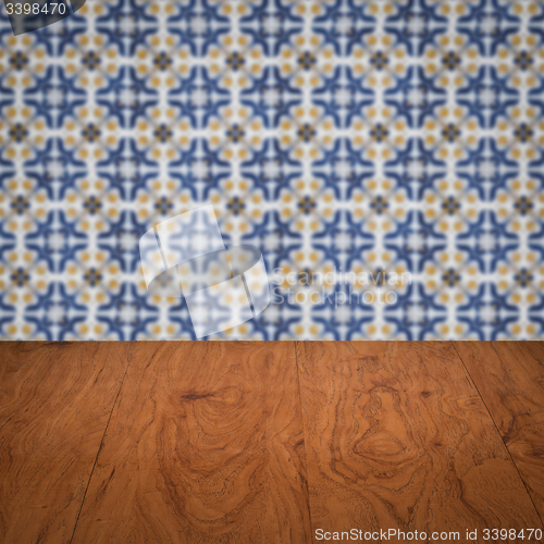 Image of Wood table top and blur vintage ceramic tile pattern wall